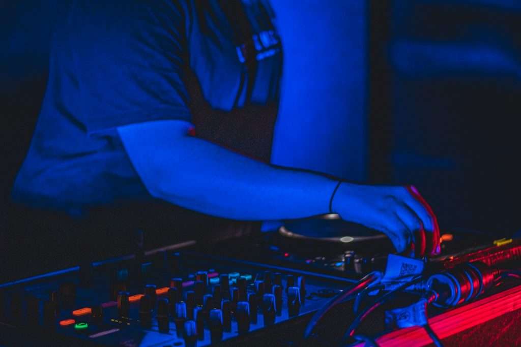 DJ performing at Vibrancy Festival during Friday night electronic music set.