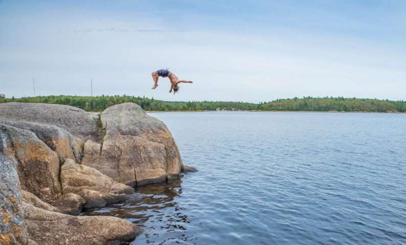 Cliff jumping into Nova Scotia National Parks.