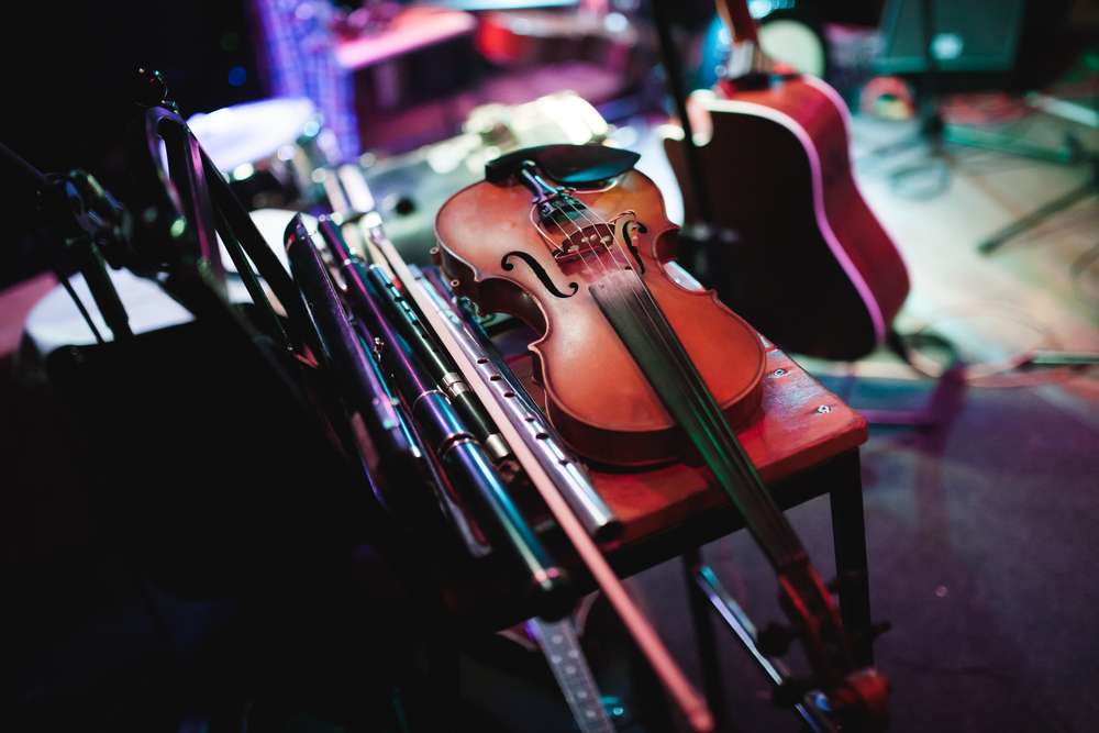 Traditional Celtic instruments including fiddle and flute on stage at the Rejigged Festival in Halifax, Nova Scotia, showcasing cultural heritage and musical innovation.