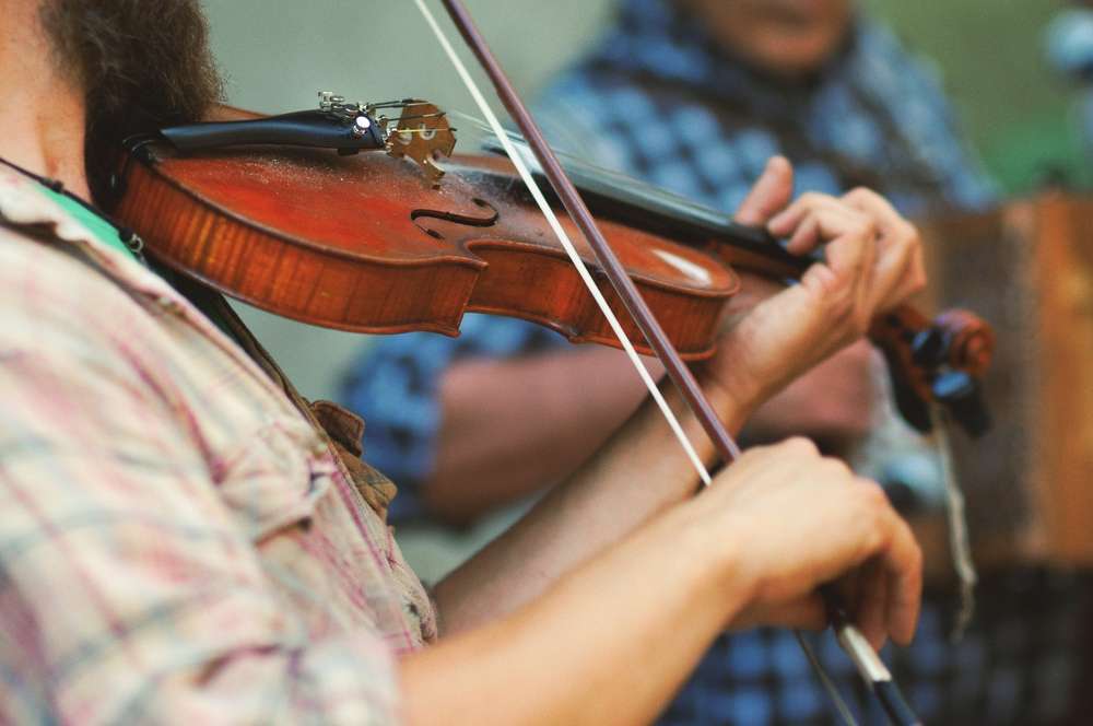 Musician playing Celtic fiddle at the Rejigged Festival in Halifax, Nova Scotia, celebrating traditional music from Ireland and Europe.