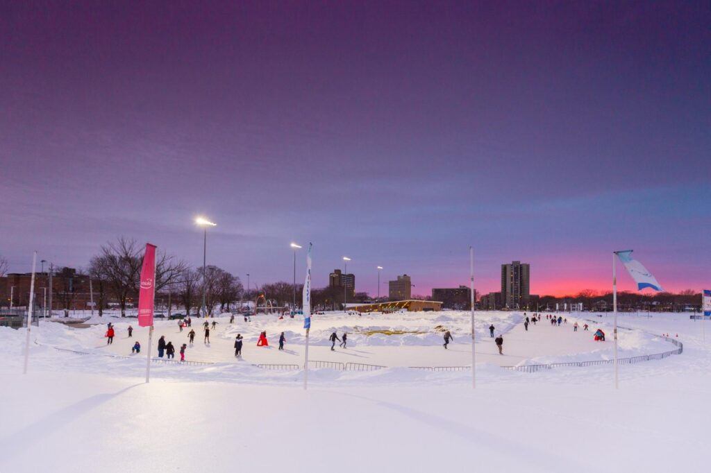 Skating taking place at the Emera Oval at dusk, a winter outing for March Break in Halifax.