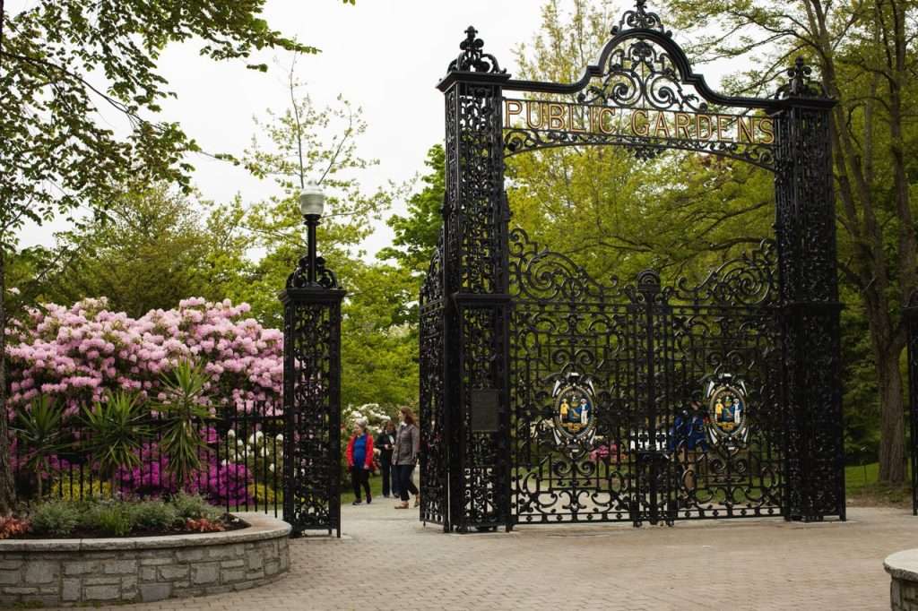 Ornate iron gates at Halifax Public Gardens with blooming flowers