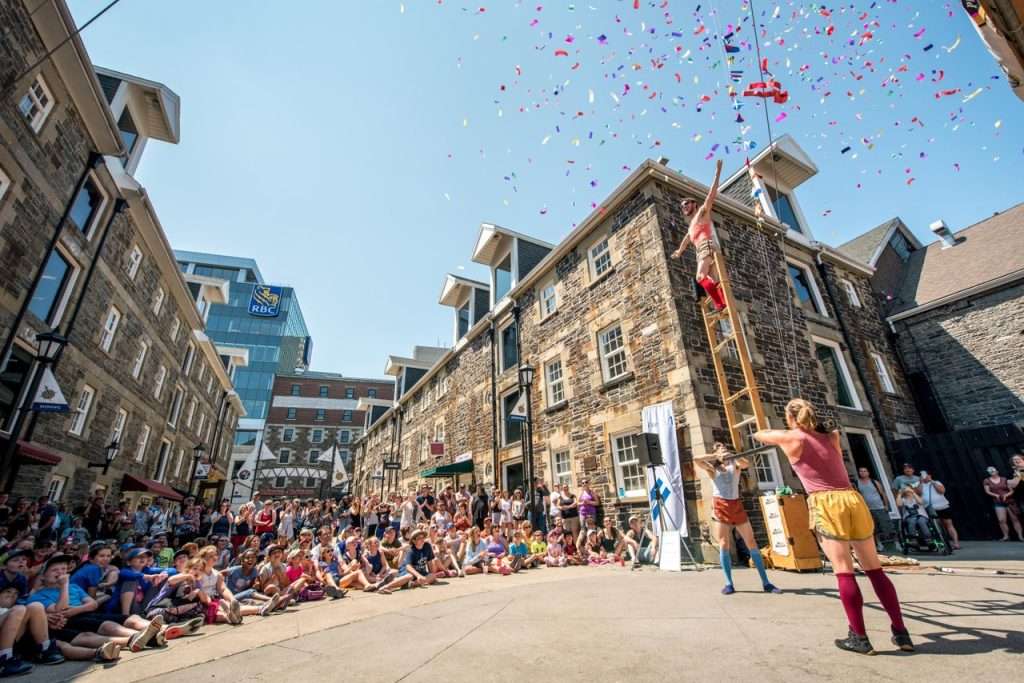 Downtown Halifax summer festivals with a crowd watching a street performance