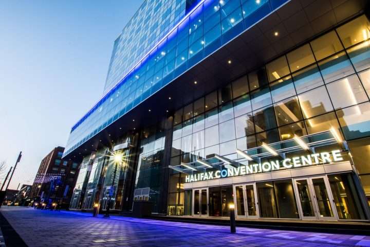 Hotels near Halifax Convention Centre guide featuring the venue's glass exterior at dusk